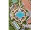 Aerial view of community pool with lounge chairs and palm trees at 3704 Via Monte Napoleone Dr, Poinciana, FL 34759