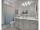 Stylish bathroom with a vanity, large mirror, and blue-themed shower curtain at 3704 Via Monte Napoleone Dr, Poinciana, FL 34759