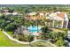 View of clubhouse with a pool and lush landscaping, complete with lounge chairs and palm trees at 3704 Via Monte Napoleone Dr, Poinciana, FL 34759