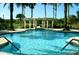 Sparkling pool with pergolas, lush landscaping, and clear water for a relaxing atmosphere at 3704 Via Monte Napoleone Dr, Poinciana, FL 34759