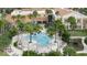 Resort-style community pool area surrounded by palm trees and seating at 3704 Via Monte Napoleone Dr, Poinciana, FL 34759