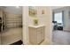 Hallway leading to a garage and a bedroom/office space with a cabinet at 3704 Via Monte Napoleone Dr, Poinciana, FL 34759