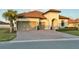 Stunning single-story home with a barrel tile roof, paver driveway, and attached two-car garage at 3704 Via Monte Napoleone Dr, Poinciana, FL 34759