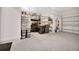 Spacious garage with epoxy flooring, storage shelves, and room for multiple vehicles at 3704 Via Monte Napoleone Dr, Poinciana, FL 34759