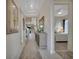 Inviting hallway showcasing an elegant console table and leading to the living spaces and bedrooms at 3704 Via Monte Napoleone Dr, Poinciana, FL 34759