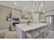 The modern kitchen includes an island with seating, recessed lights, and stainless steel appliances at 3704 Via Monte Napoleone Dr, Poinciana, FL 34759