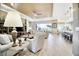 Open-concept living room featuring a coffered ceiling, ceiling fan, and an adjacent breakfast bar at 3704 Via Monte Napoleone Dr, Poinciana, FL 34759