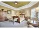 Spacious main bedroom with a decorative ceiling, natural light, and comfortable seating at 3704 Via Monte Napoleone Dr, Poinciana, FL 34759