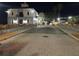 Cobblestone street view at night decorated with lights and leading to community buildings at 3704 Via Monte Napoleone Dr, Poinciana, FL 34759