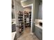 Well-organized walk-in pantry with ample shelving and storage solutions, maximizing kitchen efficiency at 3704 Via Monte Napoleone Dr, Poinciana, FL 34759