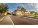 Charming streetscape with palm trees, brick-paved road, and Mediterranean-style buildings with balconies at 3704 Via Monte Napoleone Dr, Poinciana, FL 34759