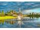 Scenic view of a water fountain spraying high in the middle of a pond on a sunny day at 3704 Via Monte Napoleone Dr, Poinciana, FL 34759