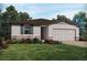 Charming one-story home with stone accents, a two-car garage, and a well-manicured lawn at 3793 Giorgio Dr, Winter Haven, FL 33884