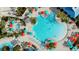 Aerial shot of community pool and recreational facilities, surrounded by lush landscaping and colorful umbrellas at 3974 Lana Ave, Davenport, FL 33897