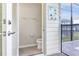 Pool bathroom with toilet, towel rack, and 'Our Pool Rules' sign with safety guidelines for guests at 3974 Lana Ave, Davenport, FL 33897