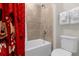 Bathroom with tiled shower and tub, and a Mickey Mouse themed shower curtain at 3974 Lana Ave, Davenport, FL 33897