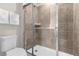 Tiled shower stall with glass door and a toilet at 3974 Lana Ave, Davenport, FL 33897