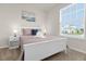 Bright bedroom with a large window, white furniture, and stylish decor create a peaceful retreat at 3974 Lana Ave, Davenport, FL 33897