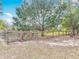 Fenced backyard featuring mature trees offers privacy and ample space at 4560 Daugharty Rd, De Leon Springs, FL 32130