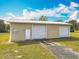 Large barn with two roll-up doors and ample parking space in front at 4560 Daugharty Rd, De Leon Springs, FL 32130