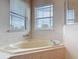 Bright bathroom featuring a soaking tub, and dual windows that provide plenty of natural lighting at 4560 Daugharty Rd, De Leon Springs, FL 32130