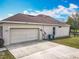 Spacious garage with an extended driveway and a well-maintained exterior at 4560 Daugharty Rd, De Leon Springs, FL 32130