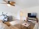 Bright living room featuring neutral walls, carpet flooring, a ceiling fan, and plenty of natural lighting at 4560 Daugharty Rd, De Leon Springs, FL 32130