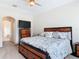 Comfortable main bedroom with a ceiling fan, a large window, and carpet flooring at 4560 Daugharty Rd, De Leon Springs, FL 32130