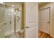 Bright bathroom featuring a shower with glass door, toilet, and neutral-toned walls at 4967 Windermere Ave, Kissimmee, FL 34746