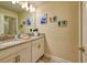 Bathroom featuring a double sink vanity, a large mirror, and tasteful decor for a relaxing space at 4967 Windermere Ave, Kissimmee, FL 34746