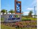 Elegant Story Lake community entrance sign surrounded by lush landscaping and vibrant flower beds at 4967 Windermere Ave, Kissimmee, FL 34746