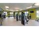 Community fitness center with various exercise machines, TVs, and ample natural light at 4967 Windermere Ave, Kissimmee, FL 34746