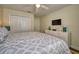 Well-lit main bedroom featuring a comfortable bed, closet, dresser, and mounted television at 4967 Windermere Ave, Kissimmee, FL 34746