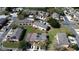 An aerial view shows this solar-paneled townhome located within a lush green community featuring many amenities at 643 Captiva Cir, Kissimmee, FL 34741