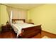 Bedroom featuring a wooden sleigh bed, patterned curtains, and a side table with lamps at 643 Captiva Cir, Kissimmee, FL 34741