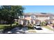 Charming two-story townhome with mature landscaping, a private driveway, and a cozy front porch area at 643 Captiva Cir, Kissimmee, FL 34741