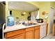 Kitchen featuring wood cabinets, and a view of the dining area at 643 Captiva Cir, Kissimmee, FL 34741