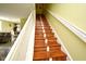 Elegant staircase with wooden steps and a white railing, connecting the home's levels at 643 Captiva Cir, Kissimmee, FL 34741