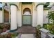 Inviting front entrance featuring a brick path and a covered porch with decorative columns at 736 W Pinewood Ct, Lake Mary, FL 32746