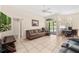 Bright living room leading to an outdoor pool area through glass doors, perfect for entertaining at 736 W Pinewood Ct, Lake Mary, FL 32746