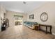 Neutral living room with tile floors, comfortable seating and an exit to the backyard at 736 W Pinewood Ct, Lake Mary, FL 32746