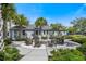 Outdoor fire pit area surrounded by Adirondack chairs and palm trees for a relaxing community gathering space at 7545 Laureate Blvd # 7202, Orlando, FL 32827