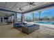 Luxury outdoor covered lounge area with seating overlooking the pool at 7545 Laureate Blvd # 7203, Orlando, FL 32827