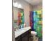 Colorful bathroom with granite countertop, decorative shower curtain and tile wall at 7873 Dausset St, Orlando, FL 32827