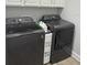 Modern laundry room showcasing updated gray washer and dryer machines at 7873 Dausset St, Orlando, FL 32827