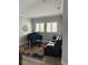 Cozy living room with a piano, leather sofa, and bright natural light from the windows at 7873 Dausset St, Orlando, FL 32827