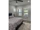 The comfortable main bedroom features multiple windows and wood-look floors at 7873 Dausset St, Orlando, FL 32827