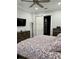 This main bedroom is large with a ceiling fan and barn door to the ensuite bathroom at 7873 Dausset St, Orlando, FL 32827