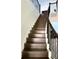 Elegant wood staircase with iron railing and white risers at 7873 Dausset St, Orlando, FL 32827