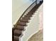 Beautiful staircase with wood treads, a curved railing, and wainscoting detail at 7873 Dausset St, Orlando, FL 32827